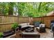 Private outdoor patio featuring stylish seating area, wooden fence and lush surrounding greenery at 120 Biscayne Nw Dr # C13, Atlanta, GA 30309