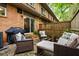 Private outdoor patio featuring stylish seating, a grill, and mature plantings at 120 Biscayne Nw Dr # C13, Atlanta, GA 30309