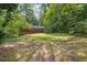 Large backyard surrounded by mature trees, offering privacy and space at 1911 Rosewood Rd, Decatur, GA 30032