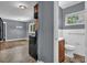 Bathroom with white tiled walls, wood vanity, and natural light, adjacent to kitchen at 1911 Rosewood Rd, Decatur, GA 30032