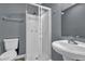 Compact bathroom featuring a pedestal sink and glass enclosed standing shower stall at 1911 Rosewood Rd, Decatur, GA 30032
