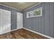 Quaint bedroom with wainscotting, wood floors, and a window at 1911 Rosewood Rd, Decatur, GA 30032