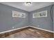 Bedroom with hardwood floors and two windows providing natural light at 1911 Rosewood Rd, Decatur, GA 30032