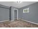 Carpeted bedroom features a window and closet at 1911 Rosewood Rd, Decatur, GA 30032