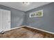 Simple bedroom with hardwood floors, a window, and closet space at 1911 Rosewood Rd, Decatur, GA 30032
