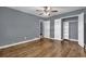 Bedroom with hardwood floors and an open closet storage space at 1911 Rosewood Rd, Decatur, GA 30032