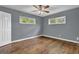 Cozy bedroom with hardwood floors, two windows, and neutral paint at 1911 Rosewood Rd, Decatur, GA 30032