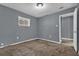 Bedroom featuring neutral walls and carpet, with natural light from a window at 1911 Rosewood Rd, Decatur, GA 30032