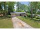 Traditional home with a long driveway and mature trees at 1911 Rosewood Rd, Decatur, GA 30032