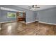 Open-concept living room featuring hardwood floors, a ceiling fan, and natural light at 1911 Rosewood Rd, Decatur, GA 30032
