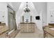 Bright bathroom boasts shower, tub, granite counters, custom vanity island, and chandelier at 765 Vinings Estates Se Dr, Mableton, GA 30126