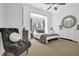 A spacious bedroom with neutral tones features large windows, a ceiling fan, and comfortable seating area at 765 Vinings Estates Se Dr, Mableton, GA 30126