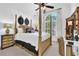 A large bedroom featuring a four-poster bed and a window letting in lots of natural light at 765 Vinings Estates Se Dr, Mableton, GA 30126