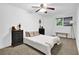 Bright bedroom features neutral walls, ceiling fan, and two dark wood nightstands at 765 Vinings Estates Se Dr, Mableton, GA 30126