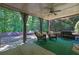 Outdoor covered patio with seating, curtains, grill, and view of the backyard at 765 Vinings Estates Se Dr, Mableton, GA 30126