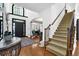 Spacious foyer with hardwood floors, staircase and decorative accents at 765 Vinings Estates Se Dr, Mableton, GA 30126