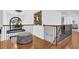 An upstairs hallway with hardwood floors features wrought iron railings and plenty of natural light at 765 Vinings Estates Se Dr, Mableton, GA 30126