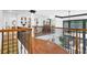 A hardwood bridge overlooks the living room below, open and airy, a dramatic second floor feature at 765 Vinings Estates Se Dr, Mableton, GA 30126