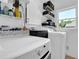 Well-lit laundry room featuring white cabinets and modern washer and dryer units at 765 Vinings Estates Se Dr, Mableton, GA 30126