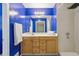Vibrant bathroom featuring a bright blue accent wall, modern vanity, and tiled flooring at 1050 Hampton Hill Ct, Lawrenceville, GA 30044