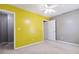 A bedroom with bright yellow walls and neutral-colored carpeting at 1050 Hampton Hill Ct, Lawrenceville, GA 30044