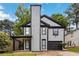 Charming two-story home featuring a covered porch, black trim, and attached garage at 1050 Hampton Hill Ct, Lawrenceville, GA 30044