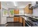 A kitchen features light-colored cabinetry, dark countertops and modern stainless steel appliances at 1050 Hampton Hill Ct, Lawrenceville, GA 30044