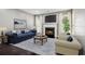 Bright living room with fireplace, blue sofa, and a large area rug, perfect for relaxation at 1050 Hampton Hill Ct, Lawrenceville, GA 30044