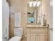 Well-lit bathroom features vanity with granite countertops, white cabinetry, and a shower with matching ceramic tile at 1942 N Akin Ne Dr, Atlanta, GA 30345