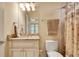 Bathroom with a vanity featuring a marble countertop, matching faucet, and neutral-colored ceramic tile in shower at 1942 N Akin Ne Dr, Atlanta, GA 30345