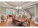 Formal dining room features hardwood floors, elegant chandelier, and access to the living room and staircase at 1942 N Akin Ne Dr, Atlanta, GA 30345