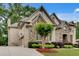 Exterior elevation of home showing side-entry garage and well maintained landscaping at 1942 N Akin Ne Dr, Atlanta, GA 30345