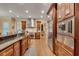 Large kitchen with stainless steel appliances, dark granite countertops, custom cabinets, and an open layout to the living space at 1942 N Akin Ne Dr, Atlanta, GA 30345