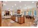 Open kitchen and dining area with stainless steel appliances, custom cabinets, granite countertops, and a center island at 1942 N Akin Ne Dr, Atlanta, GA 30345