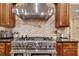 Gourmet kitchen featuring a professional-grade stove, custom cabinetry, and stylish backsplash, perfect for culinary enthusiasts at 1942 N Akin Ne Dr, Atlanta, GA 30345