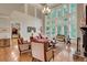 Bright and airy living room boasts soaring ceilings, a wall of windows, and elegant furnishings, perfect for relaxation at 1942 N Akin Ne Dr, Atlanta, GA 30345