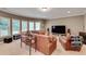 Spacious living room with multiple windows, comfortable leather sofas, and carpeted floors for relaxed living at 1942 N Akin Ne Dr, Atlanta, GA 30345