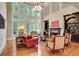 Bright and airy living room with floor-to-ceiling windows, fireplace, and built-in bookshelves at 1942 N Akin Ne Dr, Atlanta, GA 30345