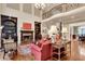 This living room features hardwood floors, a fireplace, built-in bookshelves and an elegant chandelier at 1942 N Akin Ne Dr, Atlanta, GA 30345