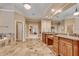 Elegant main bathroom with double sinks, granite countertops, tiled floors, and a jacuzzi tub at 1942 N Akin Ne Dr, Atlanta, GA 30345