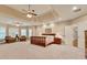 Bright main bedroom boasts a coffered ceiling, ceiling fan, and three windows with custom blinds at 1942 N Akin Ne Dr, Atlanta, GA 30345