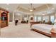 Expansive main bedroom featuring a coffered ceiling, ceiling fan, and spacious seating area with fireplace at 1942 N Akin Ne Dr, Atlanta, GA 30345