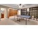 Open recreation room with built-in shelving, a ping pong table, and access to the bathroom at 1942 N Akin Ne Dr, Atlanta, GA 30345
