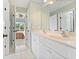Bathroom featuring a double vanity and stylish lighting with view to bedroom at 3456 Glen Mist Pl, Dacula, GA 30019