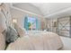 Bedroom showcasing a well-lit interior, offering a comfortable bed, workspace, and convenient access to the bathroom at 3456 Glen Mist Pl, Dacula, GA 30019