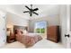 Comfortable bedroom with natural light, fan, and classic furnishings at 3456 Glen Mist Pl, Dacula, GA 30019