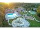 Aerial view of community amenities featuring pools, splash pad, playgrounds, clubhouse, and sports courts at 3456 Glen Mist Pl, Dacula, GA 30019