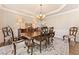 Formal dining room with a decorative chandelier and seating for eight at 3456 Glen Mist Pl, Dacula, GA 30019
