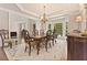 Formal dining room with chandelier, large window, and elegant wood furniture at 3456 Glen Mist Pl, Dacula, GA 30019