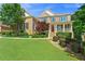 Charming home with a lush lawn, well-maintained landscaping, and a covered front porch at 3456 Glen Mist Pl, Dacula, GA 30019